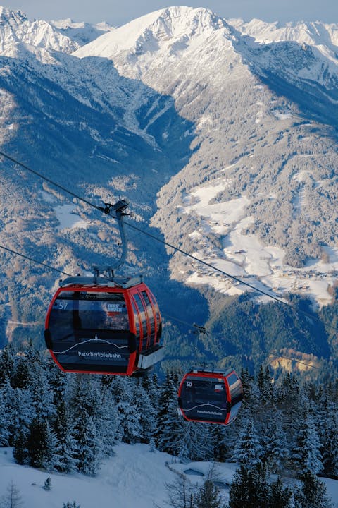 Experience a breathtaking gondola ride over the snow-covered mountains of Innsbruck, Austria.
