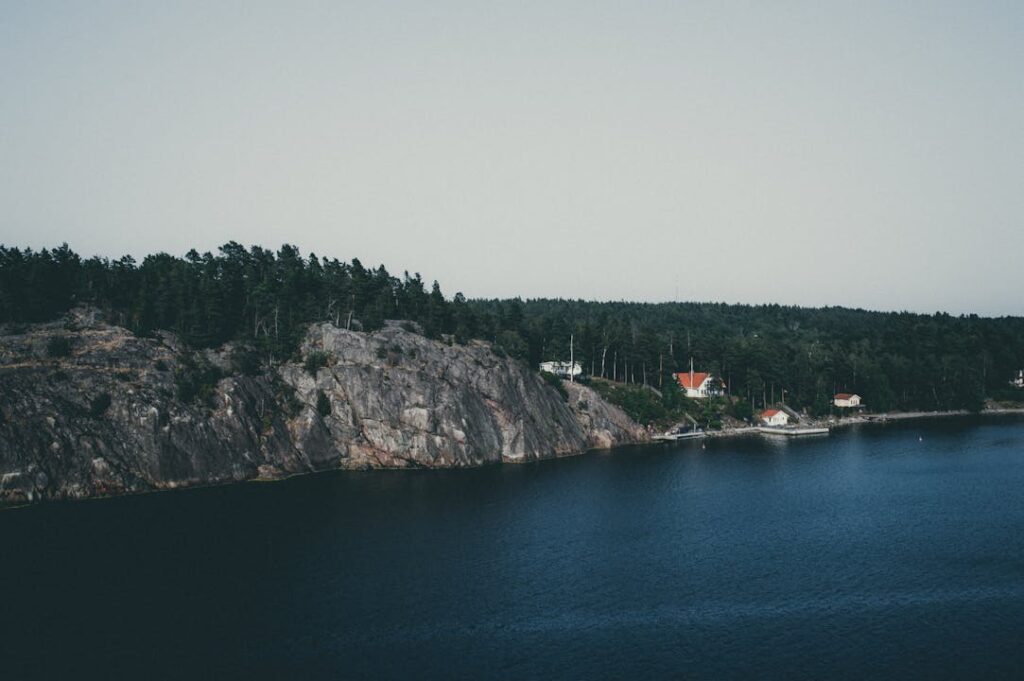 Picturesque aerial view of the coastal landscape in Stockholms län, featuring cliffs and serene waters.