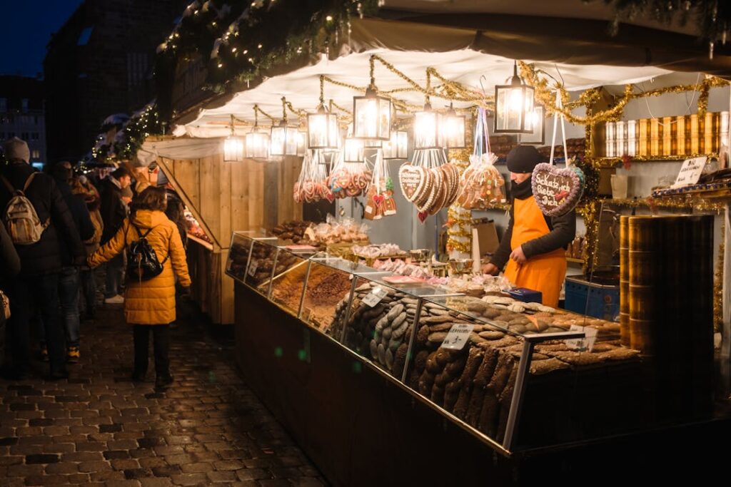 Festive evening at Nuremberg Christmas market with illuminated stalls and traditional gingerbread.