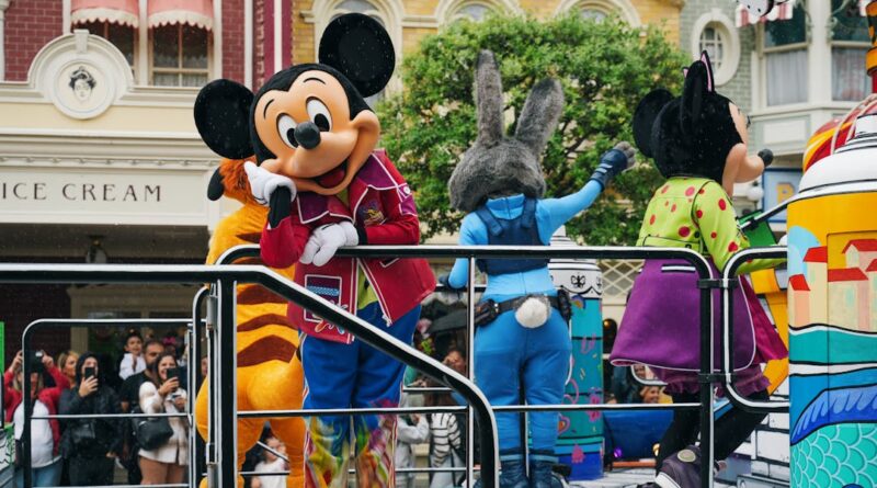 Vibrant Disneyland Paris parade with iconic Disney mascot characters entertaining the crowd.