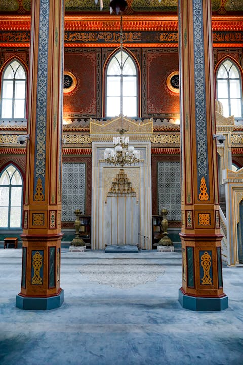 Captivating view of a mosque's detailed interior with vibrant columns and intricate designs.