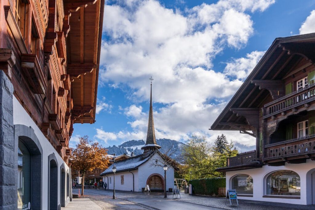 Explore the picturesque streets of Gstaad, Switzerland, with traditional alpine architecture and scenic views.
