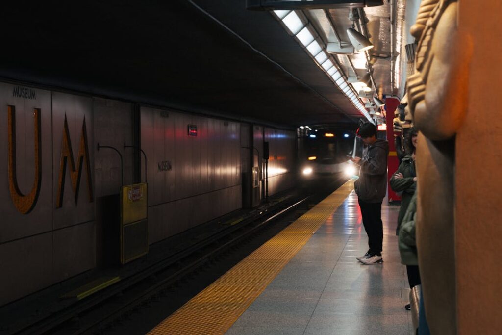Passengers wait at Toronto's Museum subway station as a train arrives.