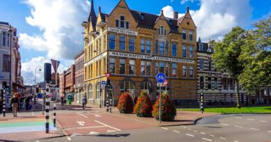 Street view of a historic building in central Haarlem, Netherlands under a blue sky.