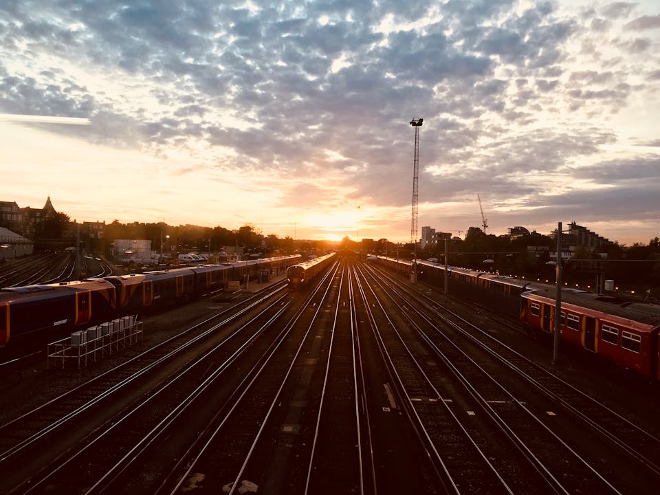 A stunning sunset view over railway tracks with trains lined up, capturing a moment of urban tranquility.