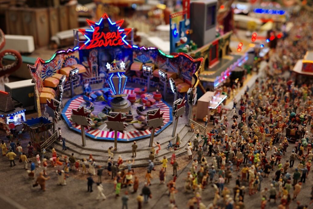a crowd of people standing around a carnival ride