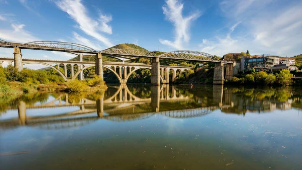 Scenic view of the Peso da Régua bridge reflecting in Douro River, Portugal.